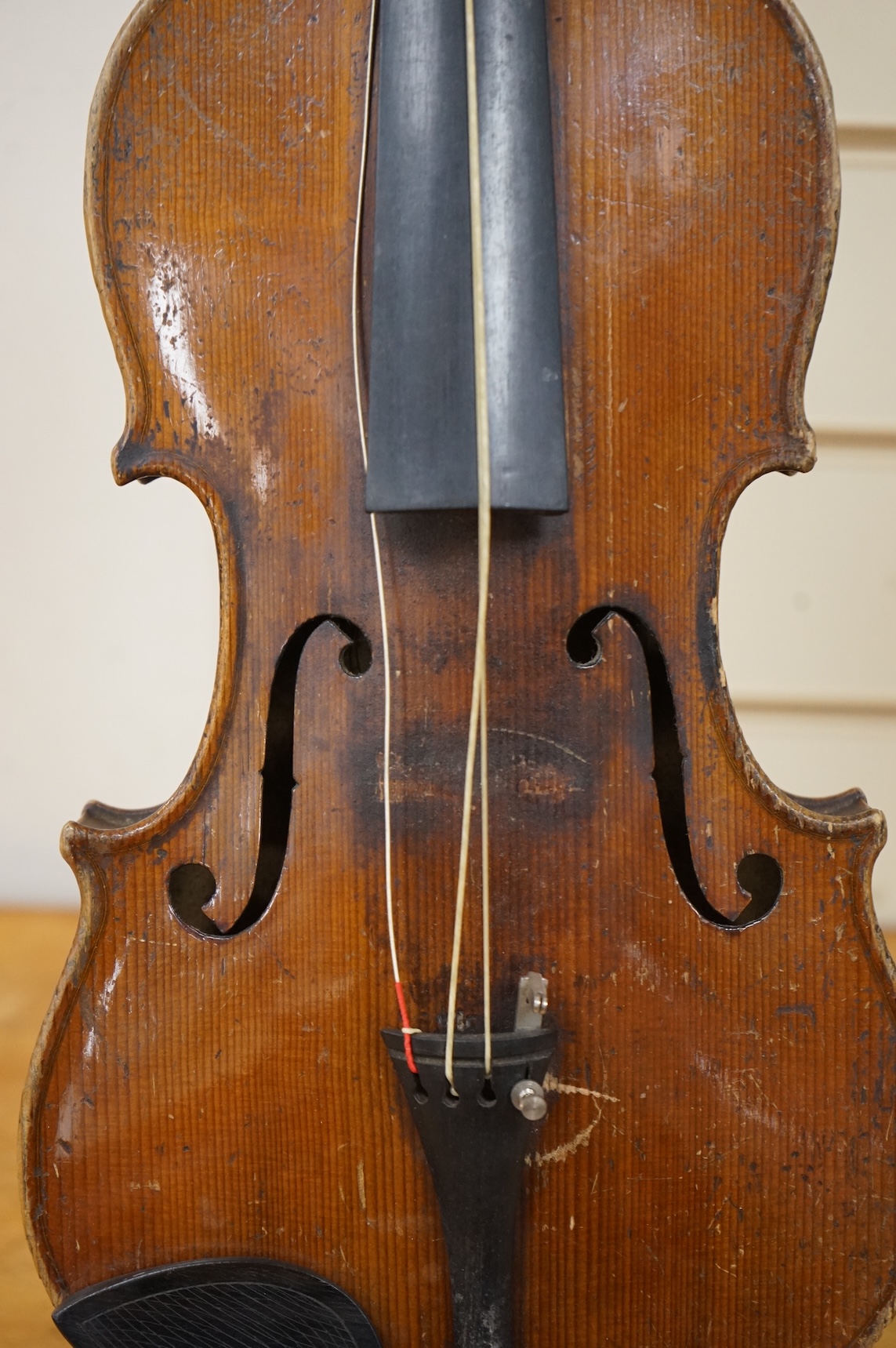 Five cased 20th century violins, including; a German violin, two Czech violins, a three-quarter size violin with a label for Bienfait, and a Romanian quarter size violin, all in cases or the remains of cases.